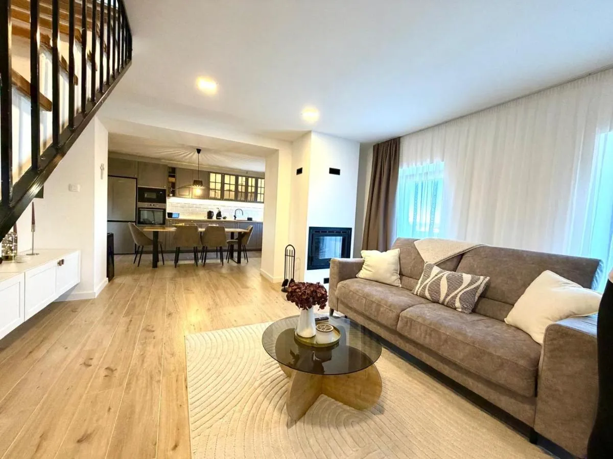 Bright open-plan living room and kitchen at Villa Billubium