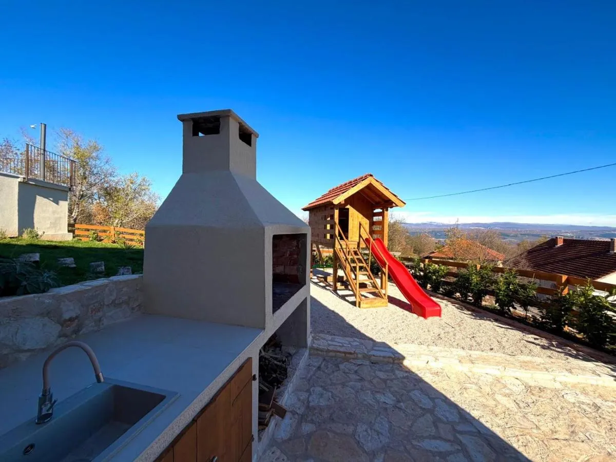 Outdoor fireplace and children’s playground beside the villa