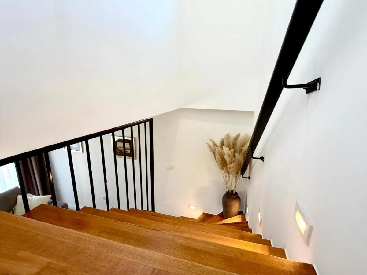 Wooden interior staircase with black metal railing