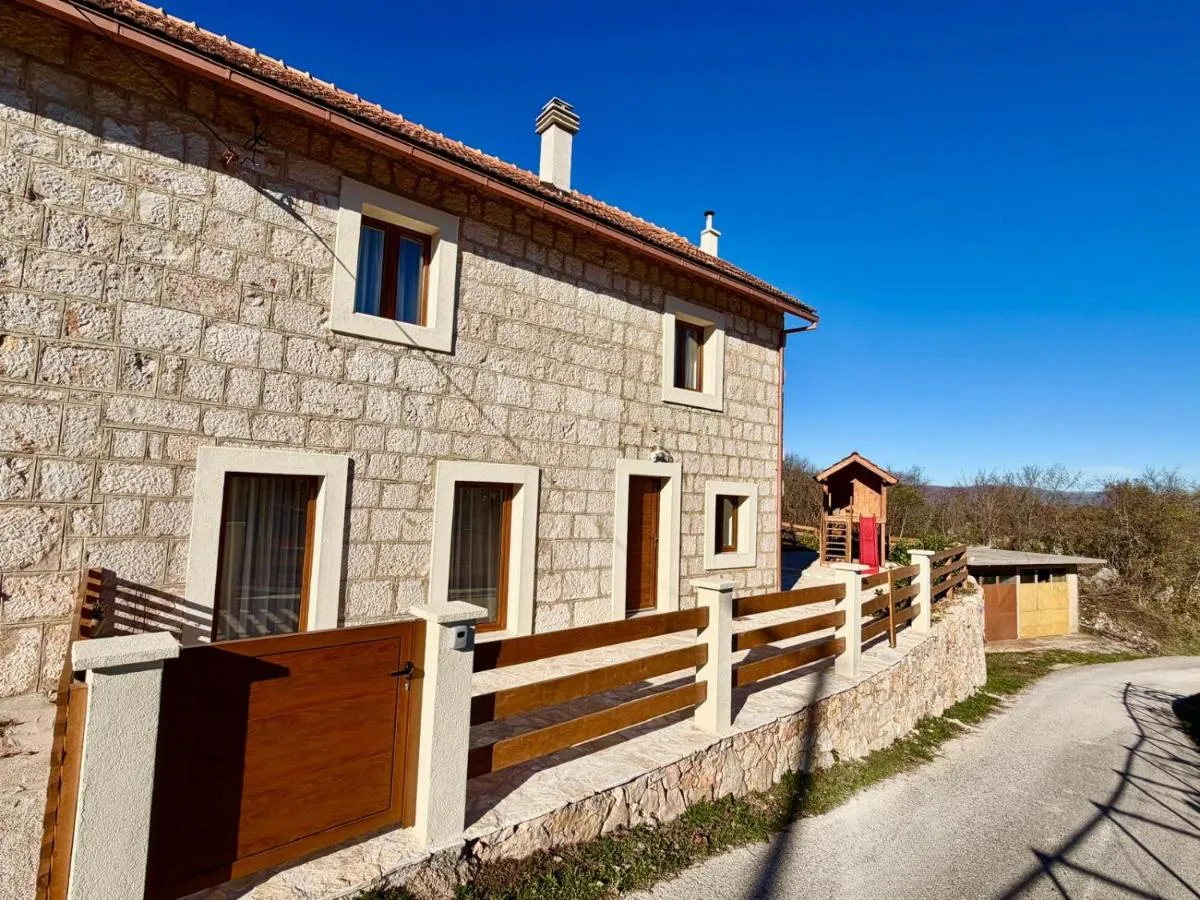 Stone house exterior and fenced private entrance