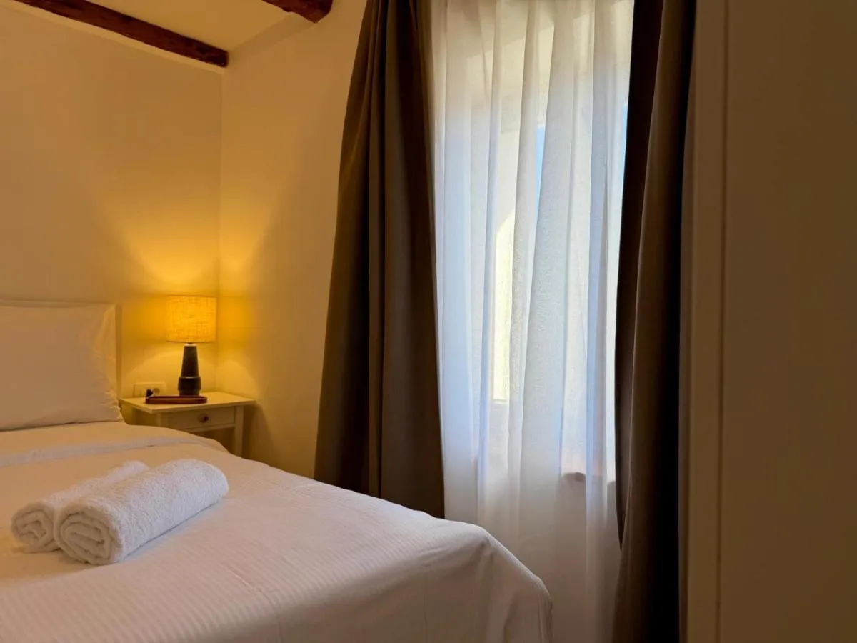 Warm bedside lighting and fresh towels in the bedroom