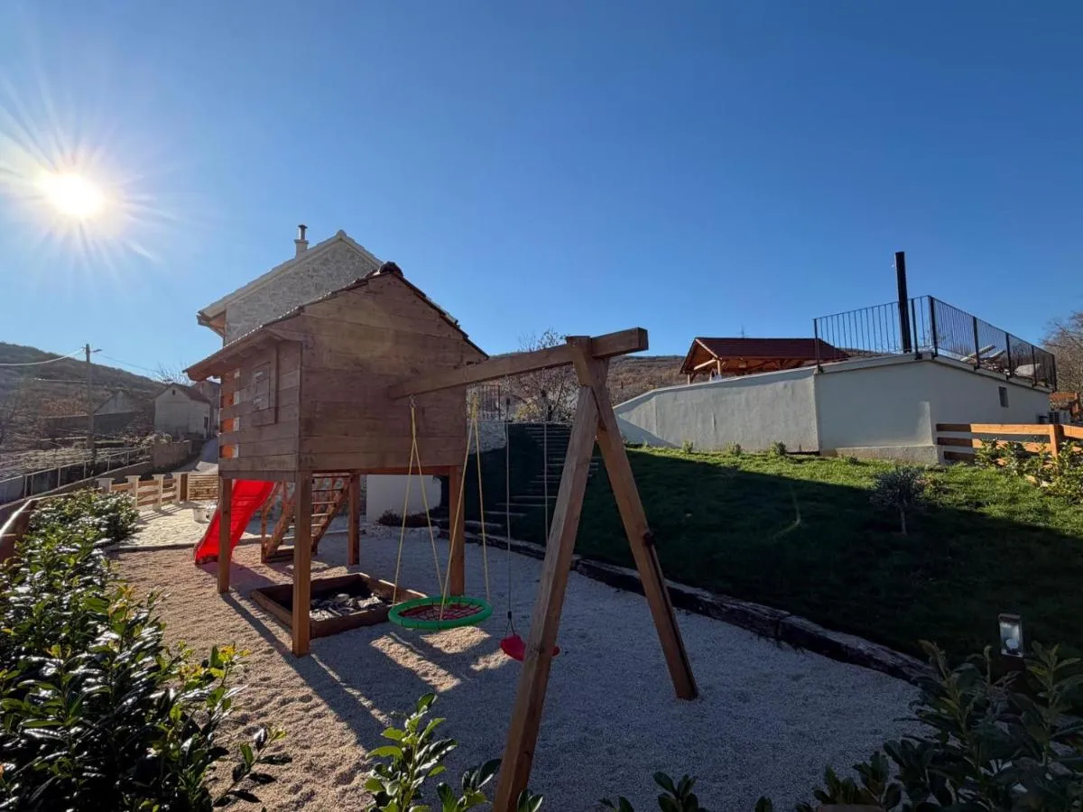 Children’s playground with swings and slide in the garden