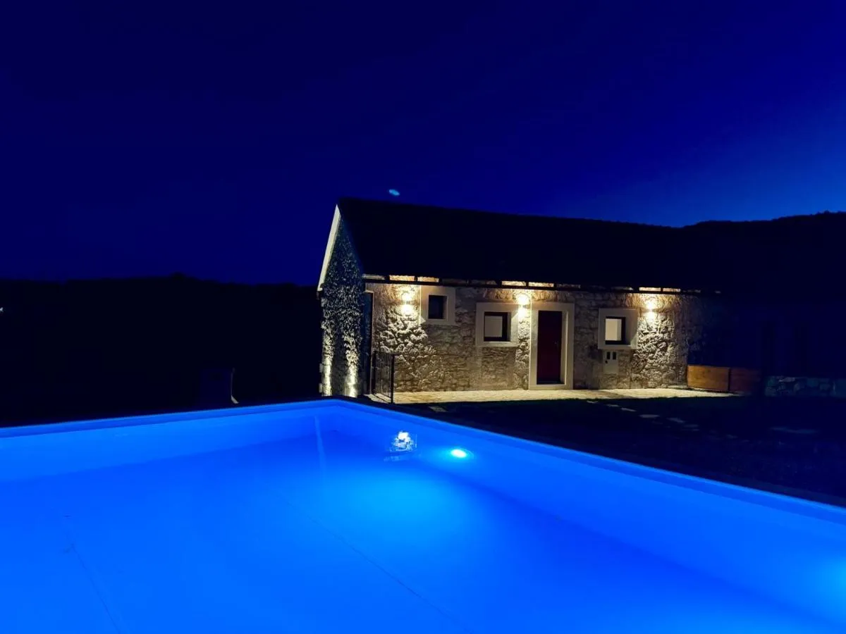 Private swimming pool illuminated in blue at night