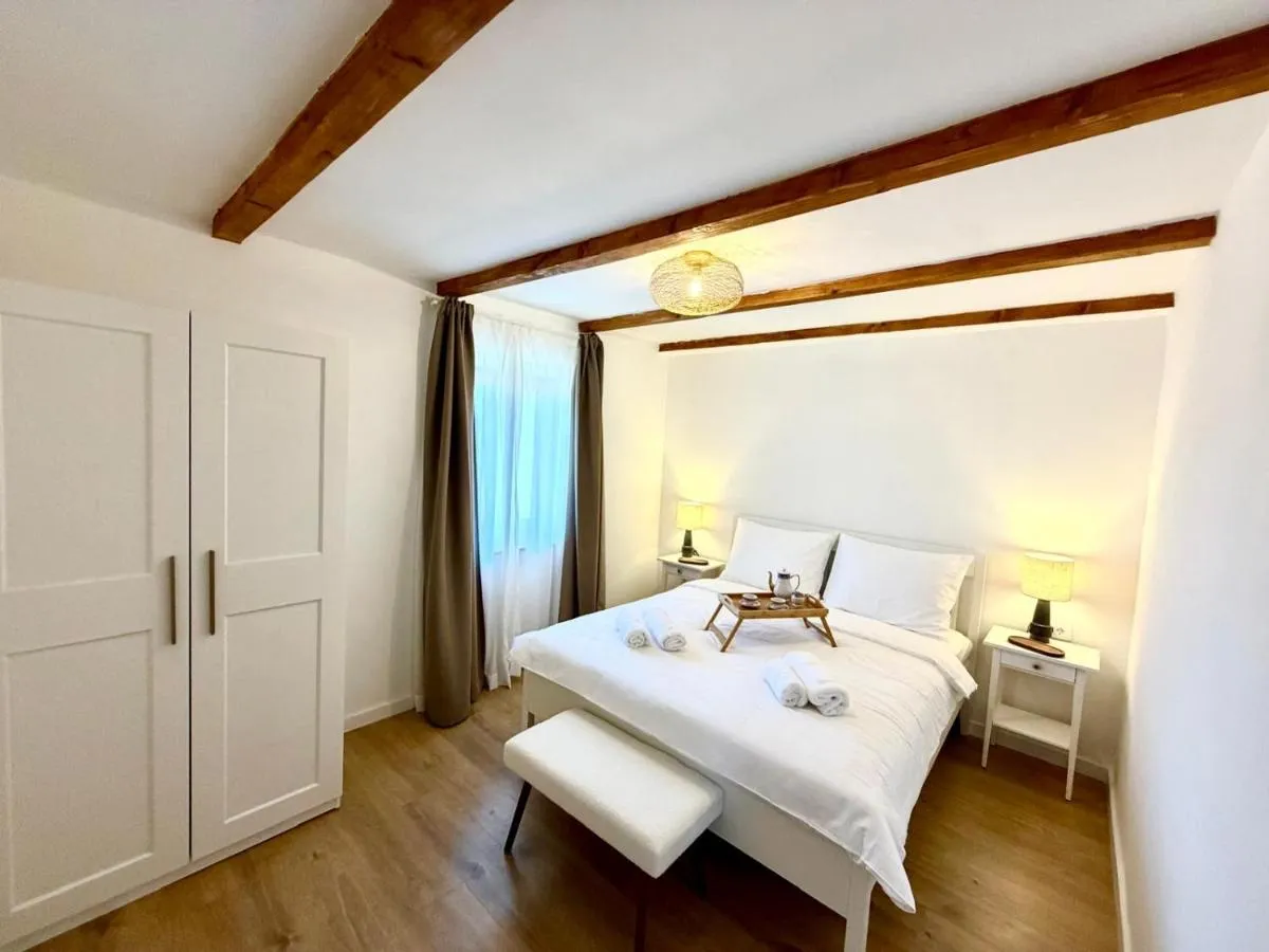 Double bedroom with wardrobe, bench and timber beams